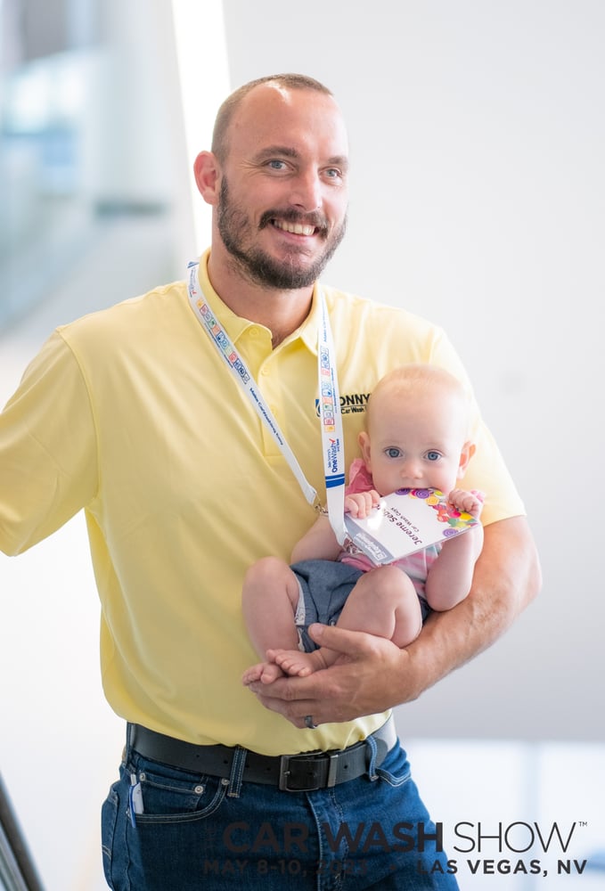 Man holding baby at The Car Wash Show
